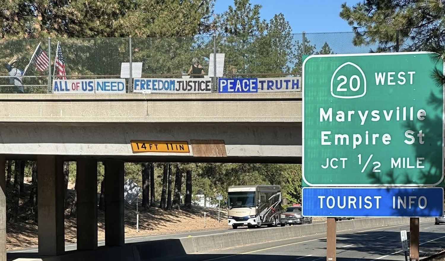 Bridge Brigade members display a message reading "All of us need freedom, justice, peace and truth."